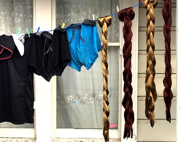 A washing line with shorts and long braids.