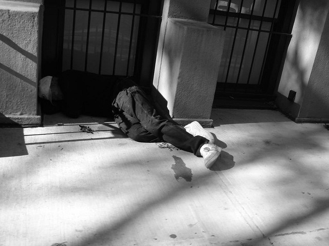 Homeless person sleeping in a doorway. Photo by Dan Dickinson
